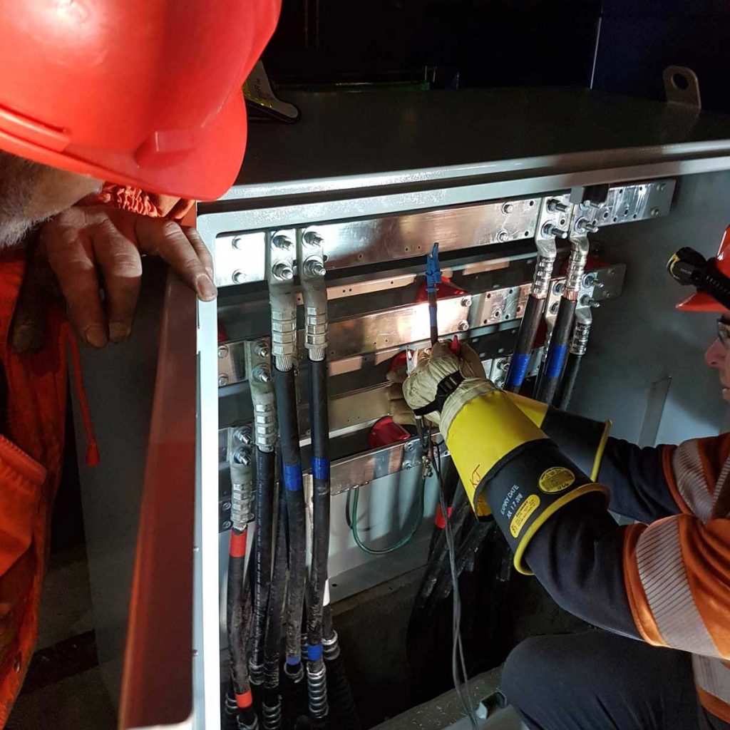 Electricians repairing electric panel