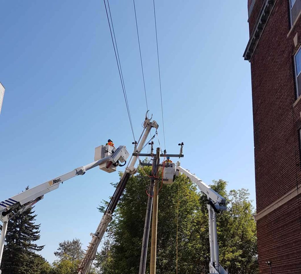 A utility worker maintaining the wires.